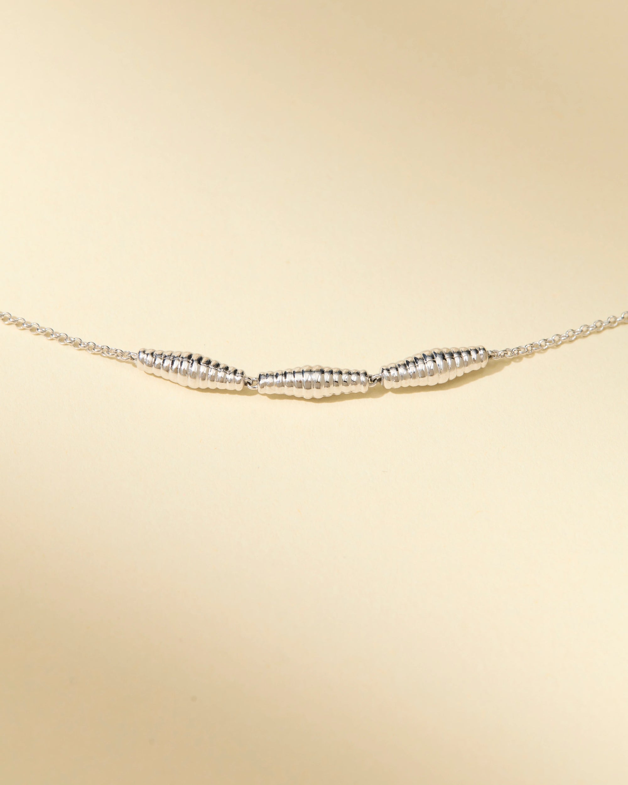 Close-up of silver croissant necklace – timeless and easy-to-wear with signature clasp