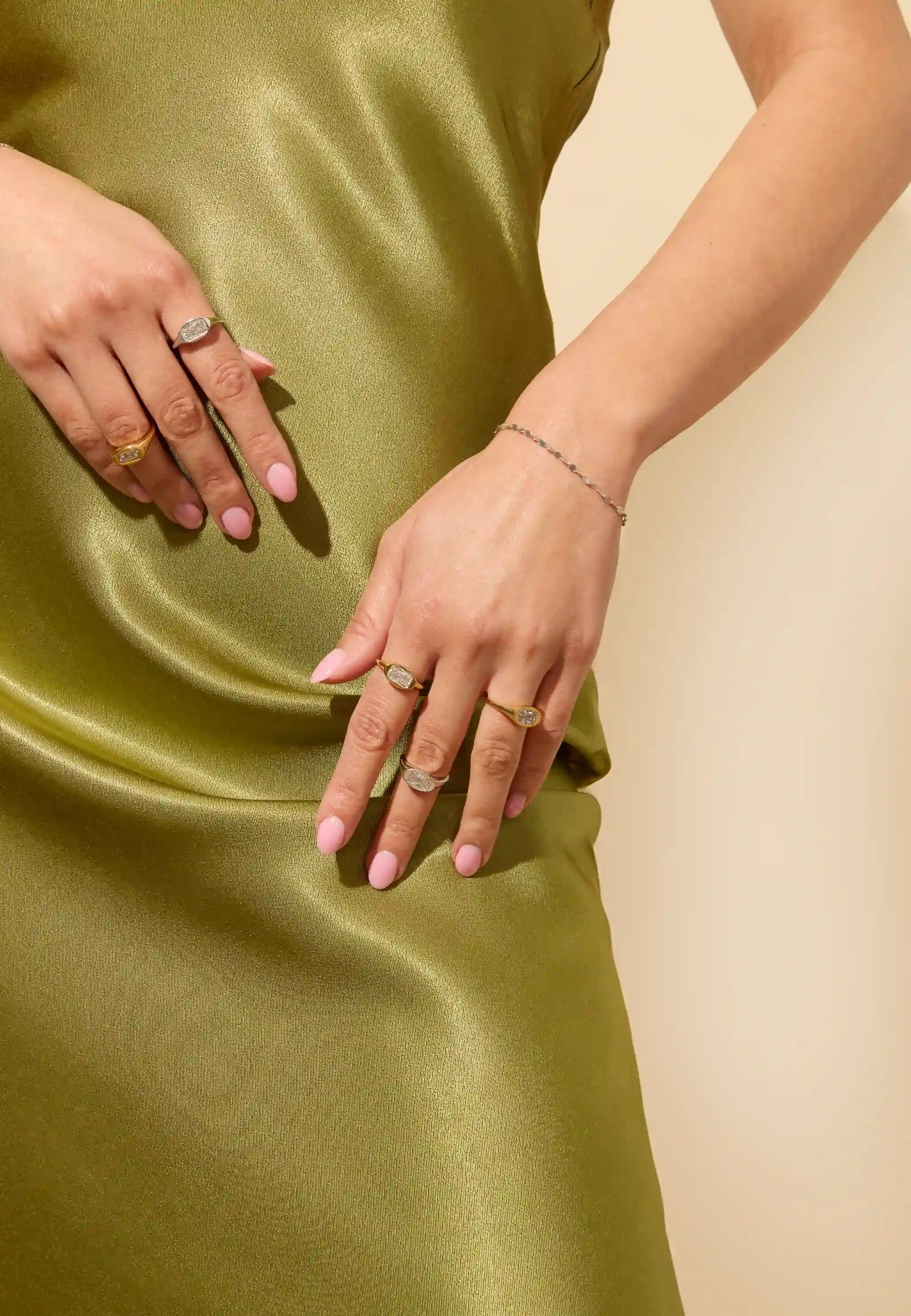Layered silver and gold jewelry - signet ring and chain bracelet stack from Claspe