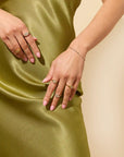 Layered silver and gold jewelry - signet ring and chain bracelet stack from Claspe